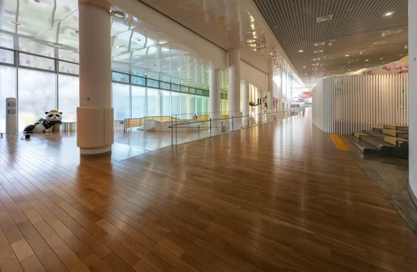 A hallway featuring wooden floors, showcasing a commercial flooring project.